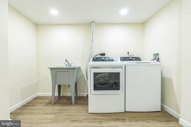 13029 Clarion Rd, Fort Washington, MD 20744 - washroom with washing machine and dryer, recessed lighting, wood finished floors, and baseboards