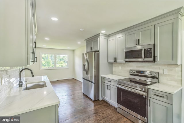 13029 Clarion Rd, Fort Washington, MD 20744 - kitchen featuring stainless steel appliances, a sink, dark wood-type flooring, backsplash, and light stone counters