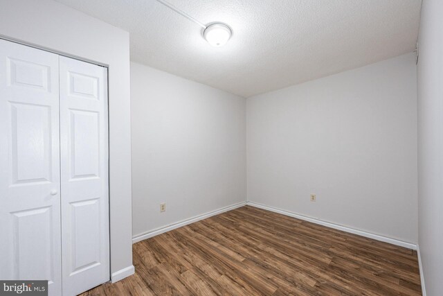 1836 Metzerott Rd Unit T-15, Hyattsville, MD 20783 - unfurnished bedroom featuring wood finished floors, a closet, baseboards, and a textured ceiling