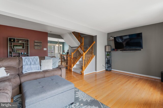 233 Windsor Ct, Quakertown, PA 18951 - living area featuring stairs, wood finished floors, a chandelier, and baseboards