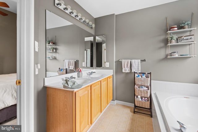 233 Windsor Ct, Quakertown, PA 18951 - ensuite bathroom featuring double vanity, a garden tub, baseboards, and ceiling fan