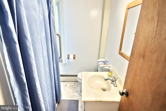 533 W Broadway, Red Lion, PA 17356 - bathroom featuring a baseboard heating unit, toilet, and vanity