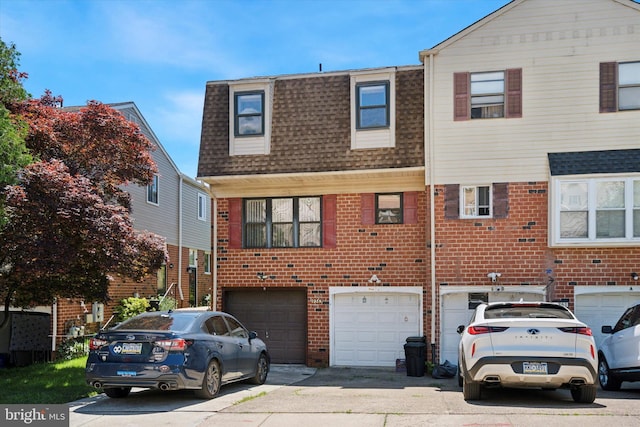 9363 Neil Rd Unit A, Philadelphia, PA 19115 - view of front of home with a garage, driveway, a shingled roof, and brick siding
