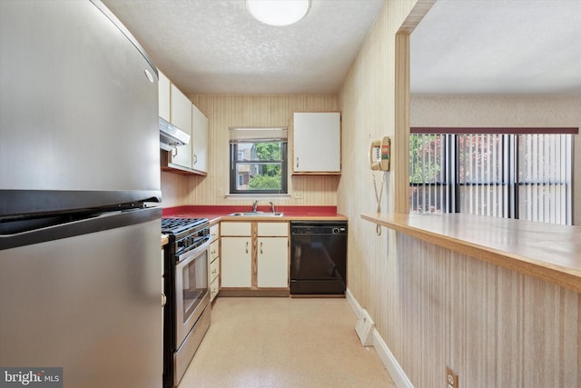 9363 Neil Rd Unit A, Philadelphia, PA 19115 - kitchen with appliances with stainless steel finishes, a sink, under cabinet range hood, white cabinets, and a textured ceiling