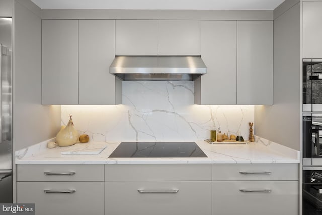 2186 Chesapeake Harbour Dr E, Annapolis, MD 21403 - kitchen with under cabinet range hood, black appliances, tasteful backsplash, gray cabinetry, and modern cabinets