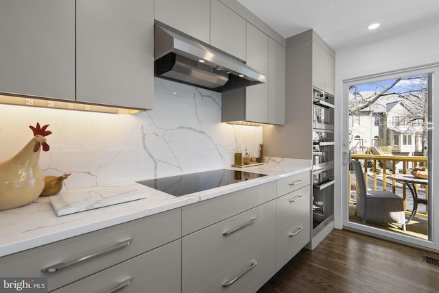 2186 Chesapeake Harbour Dr E, Annapolis, MD 21403 - kitchen featuring gray cabinets, black electric cooktop, under cabinet range hood, decorative backsplash, and recessed lighting