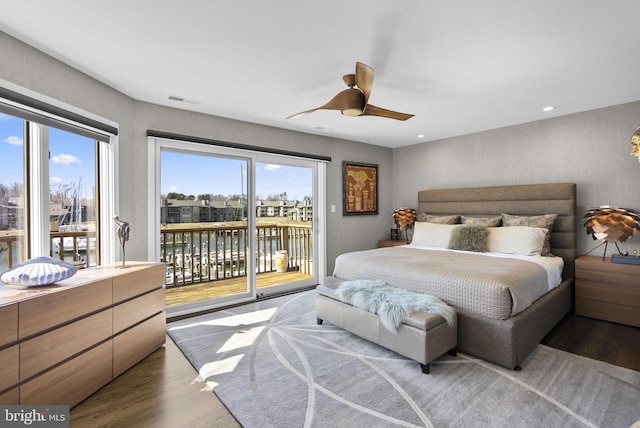 2186 Chesapeake Harbour Dr E, Annapolis, MD 21403 - bedroom featuring access to exterior, wood finished floors, multiple windows, a water view, and recessed lighting