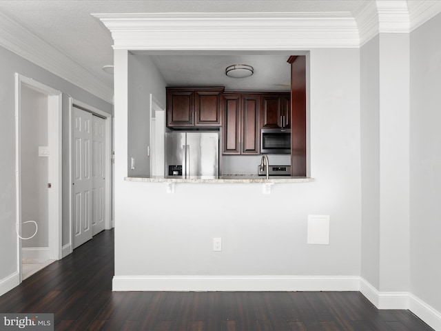 4141 N Henderson Rd N Unit 809, Arlington, VA 22203 - kitchen with appliances with stainless steel finishes, dark wood-style flooring, ornamental molding, light stone counters, and baseboards