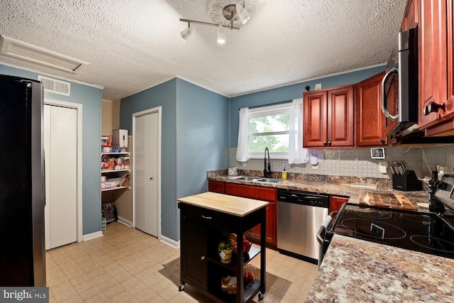 35 Holly Corner Rd, Fredericksburg, VA 22406 - kitchen featuring stainless steel appliances, a sink, a textured ceiling, backsplash, and light countertops