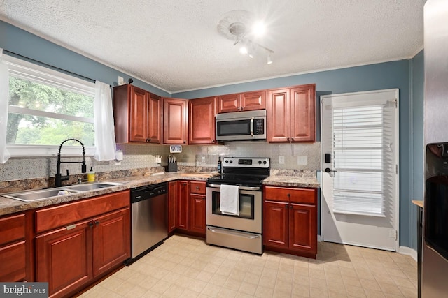 35 Holly Corner Rd, Fredericksburg, VA 22406 - kitchen with stainless steel appliances, a sink, a textured ceiling, tasteful backsplash, and baseboards