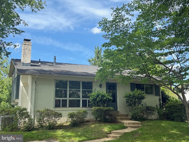 10406 Forest Ave, Fairfax, VA 22030 - view of front of home with brick siding, a chimney, and entry steps