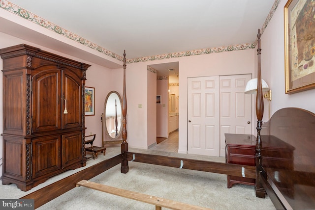 3801 Canterbury Rd Unit 817, Baltimore, MD 21218 - bedroom with light colored carpet, a closet, and baseboards