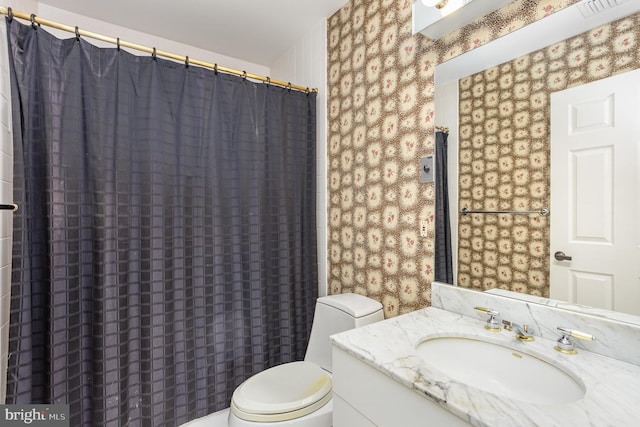 3801 Canterbury Rd Unit 817, Baltimore, MD 21218 - full bathroom with wallpapered walls, toilet, vanity, and a shower with curtain