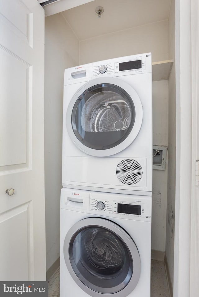 3801 Canterbury Rd Unit 817, Baltimore, MD 21218 - washroom featuring stacked washer / dryer and baseboards