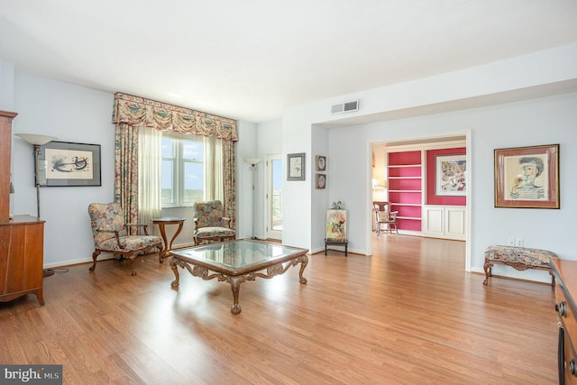 3801 Canterbury Rd Unit 817, Baltimore, MD 21218 - living area featuring light wood finished floors, built in features, and baseboards