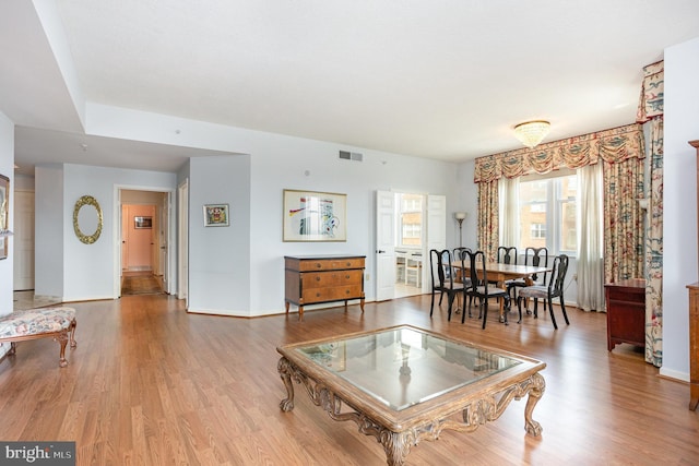 3801 Canterbury Rd Unit 817, Baltimore, MD 21218 - living room featuring wood finished floors and baseboards