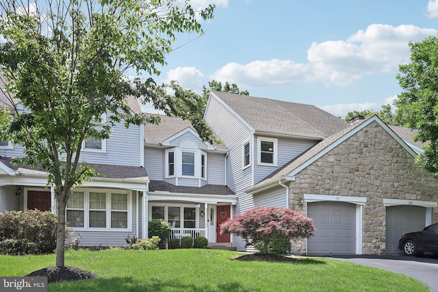 131 Blue Ribbon Dr, North Wales, PA 19454 - view of front of house featuring stone siding, a garage, a front lawn, asphalt driveway, and a shingled roof
