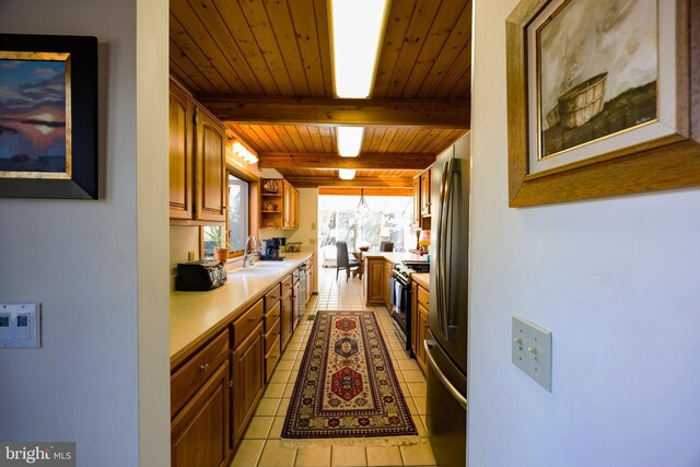 105 Fern Creek Ln, Martinsburg, WV 25404 - kitchen with range with gas cooktop, light tile patterned flooring, light countertops, wood ceiling with exposed beams, and freestanding refrigerator