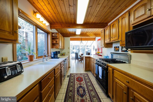 105 Fern Creek Ln, Martinsburg, WV 25404 - kitchen with gas stove, a sink, black microwave, light countertops, and wooden ceiling with exposed beams