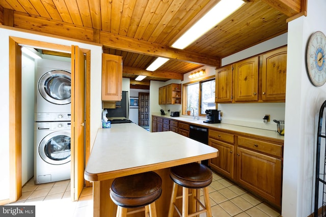 105 Fern Creek Ln, Martinsburg, WV 25404 - kitchen featuring stacked washing machine and dryer, light tile patterned flooring, a kitchen bar, a peninsula, and wood ceiling with exposed beams