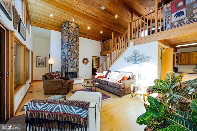 105 Fern Creek Ln, Martinsburg, WV 25404 - living room with high vaulted ceiling, stairs, a fireplace, wooden ceiling with exposed beams, and light wood finished floors