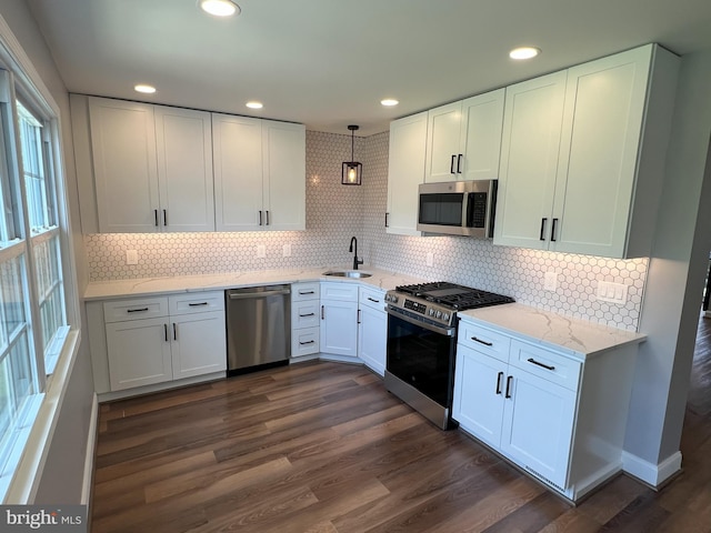 1537 W High St, Haddon Heights, NJ 08035 - kitchen with appliances with stainless steel finishes, a sink, white cabinets, dark wood finished floors, and decorative backsplash
