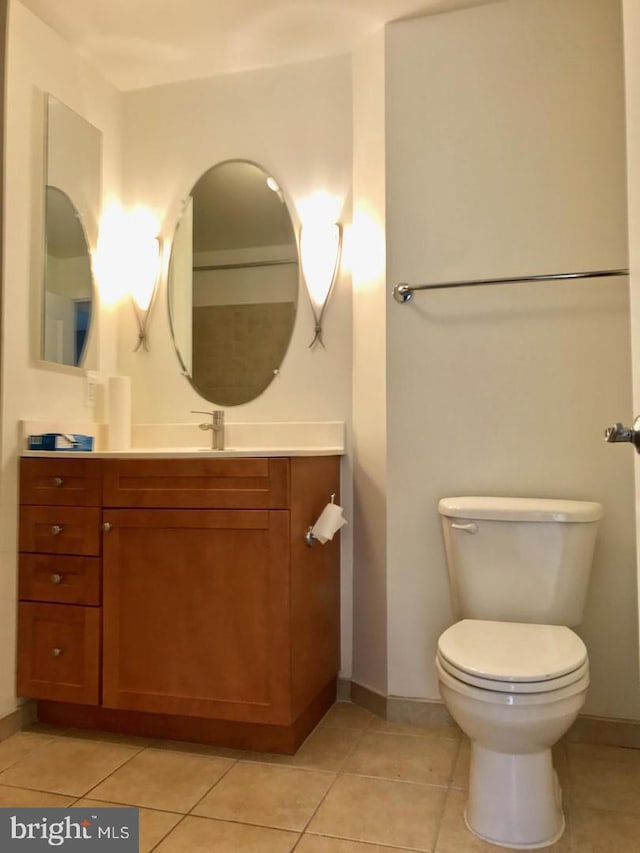 1111 11th St NW Unit 307, Washington, DC 20001 - bathroom with vanity, toilet, tile patterned flooring, and baseboards