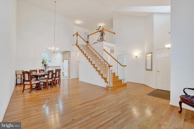 259 Prospect Cir Unit 8, Shrewsbury, PA 17361 - dining room with a towering ceiling, a chandelier, stairway, and wood finished floors