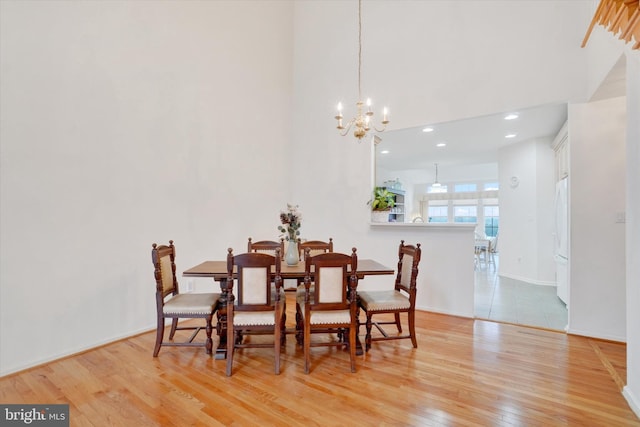 259 Prospect Cir Unit 8, Shrewsbury, PA 17361 - dining area featuring light wood-style flooring, a chandelier, recessed lighting, a towering ceiling, and baseboards