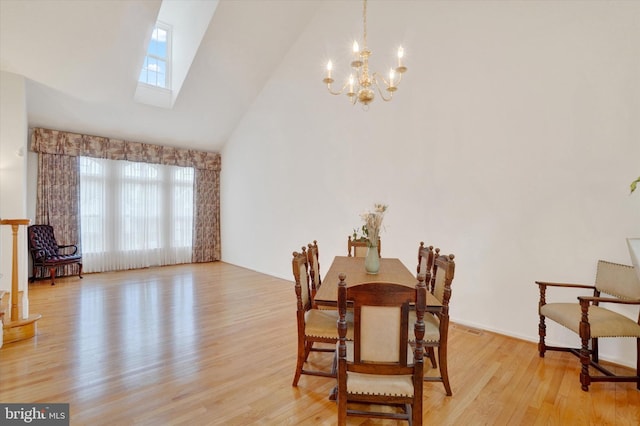 259 Prospect Cir Unit 8, Shrewsbury, PA 17361 - dining room featuring a skylight, a chandelier, light wood-style floors, and high vaulted ceiling