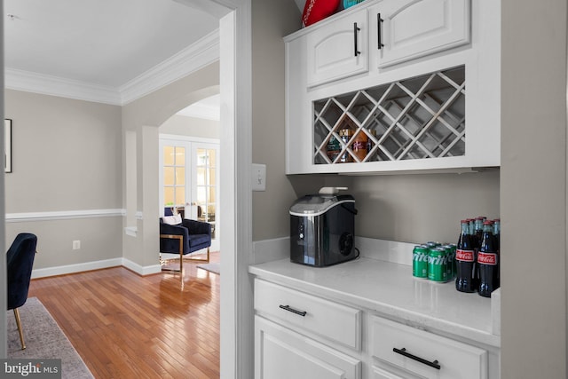 12801 Willow Marsh Ln, Bowie, MD 20720 - indoor dry bar with arched walkways, ornamental molding, light wood finished floors, and baseboards