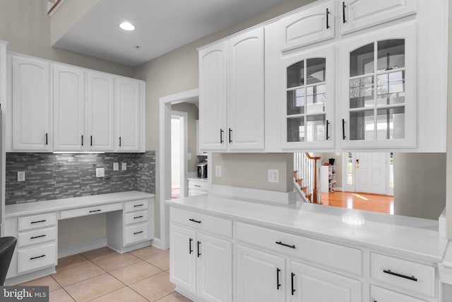 12801 Willow Marsh Ln, Bowie, MD 20720 - kitchen featuring glass insert cabinets, tasteful backsplash, white cabinets, light tile patterned floors, and recessed lighting