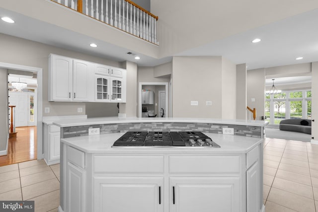 12801 Willow Marsh Ln, Bowie, MD 20720 - kitchen with a chandelier, light tile patterned flooring, stainless steel gas cooktop, light countertops, and recessed lighting