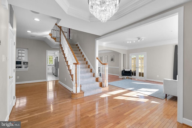 12801 Willow Marsh Ln, Bowie, MD 20720 - entryway with arched walkways, stairs, wood-type flooring, crown molding, and french doors