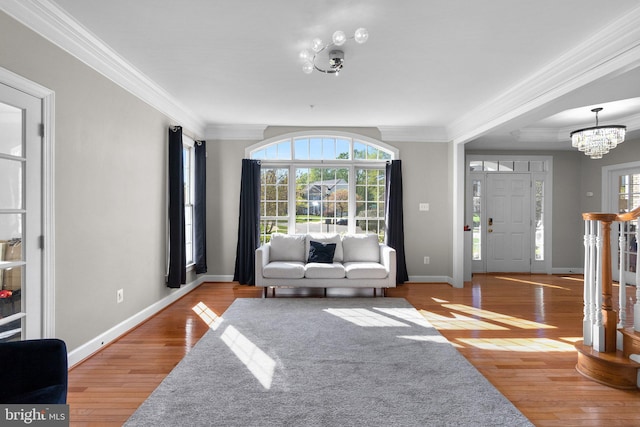 12801 Willow Marsh Ln, Bowie, MD 20720 - living area with a chandelier, ornamental molding, wood finished floors, and baseboards