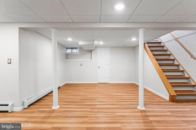 304 Terrace Ave, Toms River, NJ 08753 - basement featuring a baseboard heating unit, baseboards, wood finished floors, recessed lighting, and a drop ceiling