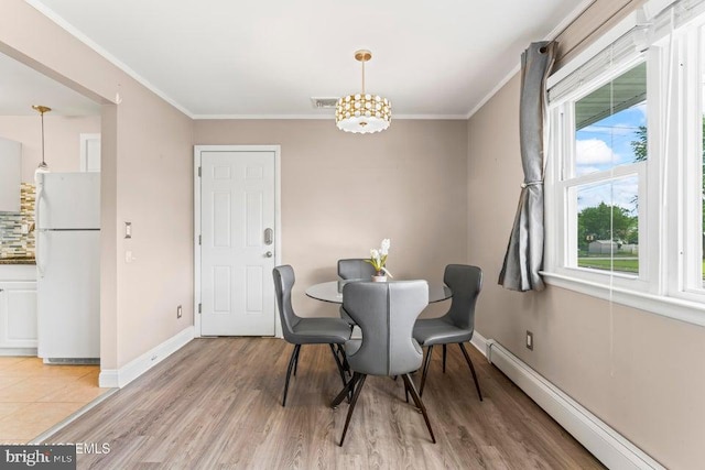 304 Terrace Ave, Toms River, NJ 08753 - dining space featuring a baseboard radiator, ornamental molding, light wood-style floors, baseboards, and a chandelier