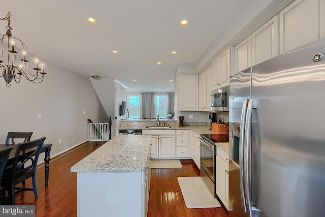 888 S Macon St, Baltimore, MD 21224 - kitchen with appliances with stainless steel finishes, a sink, a kitchen island, dark wood finished floors, and recessed lighting