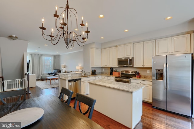888 S Macon St, Baltimore, MD 21224 - kitchen with appliances with stainless steel finishes, open floor plan, a sink, dark wood-style floors, and recessed lighting