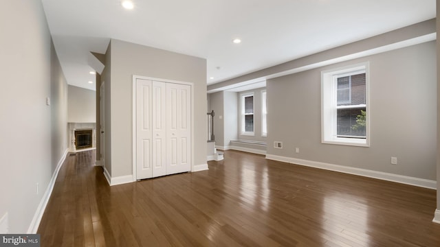 7804 Ardleigh St, Philadelphia, PA 19118 - unfurnished living room featuring dark wood-style flooring, a glass covered fireplace, baseboards, and recessed lighting