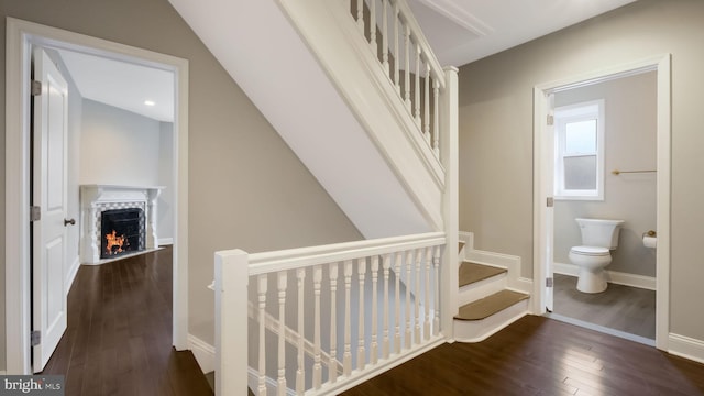 7804 Ardleigh St, Philadelphia, PA 19118 - stairway with hardwood / wood-style flooring, a warm lit fireplace, and baseboards