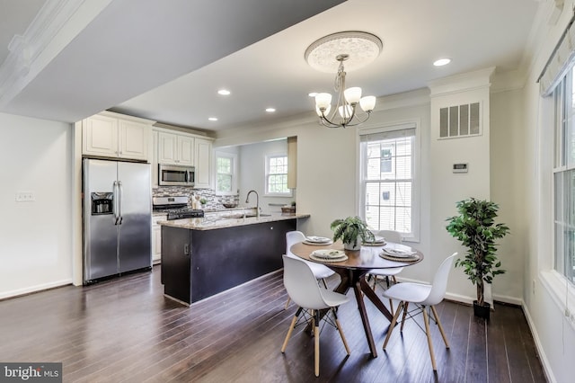 3404 Shepherd St, Mount Rainier, MD 20712 - dining area with a chandelier, dark wood-style floors, ornamental molding, baseboards, and recessed lighting