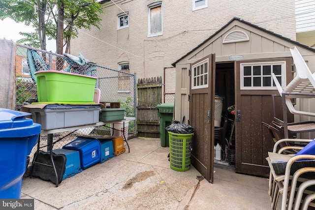 2715 E Madison St, Baltimore, MD 21205 - back of property with board and batten siding, brick siding, and a patio
