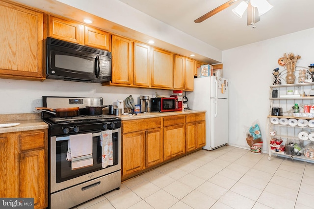 2715 E Madison St, Baltimore, MD 21205 - kitchen with black microwave, gas stove, freestanding refrigerator, light countertops, and recessed lighting