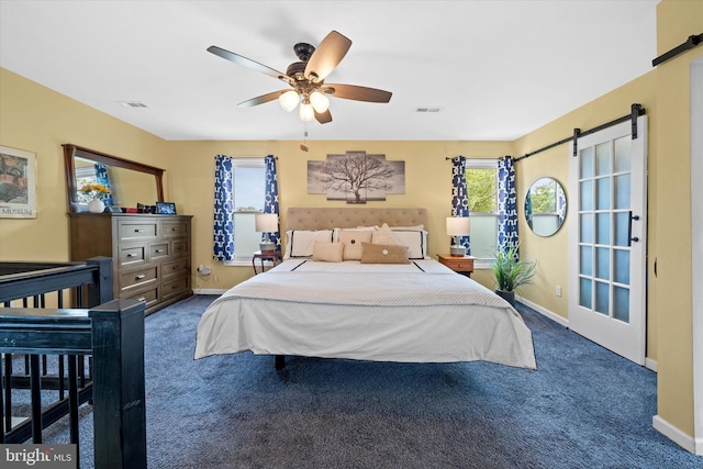 1408 Riverview Ave, Wilmington, DE 19806 - carpeted bedroom with a barn door, baseboards, and a ceiling fan