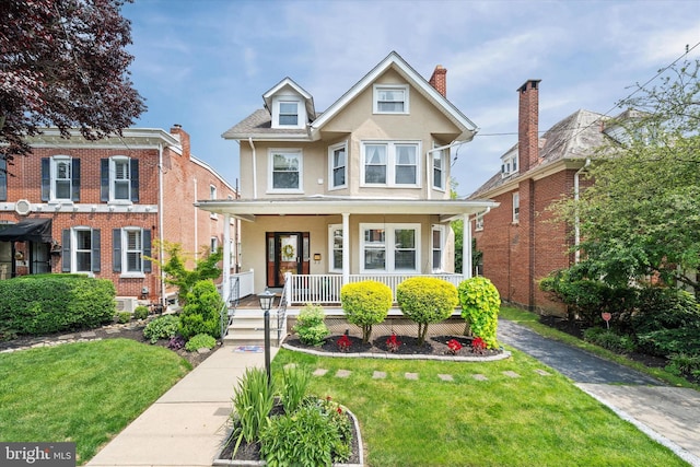 1408 Riverview Ave, Wilmington, DE 19806 - view of front facade with covered porch, stucco siding, and a front yard