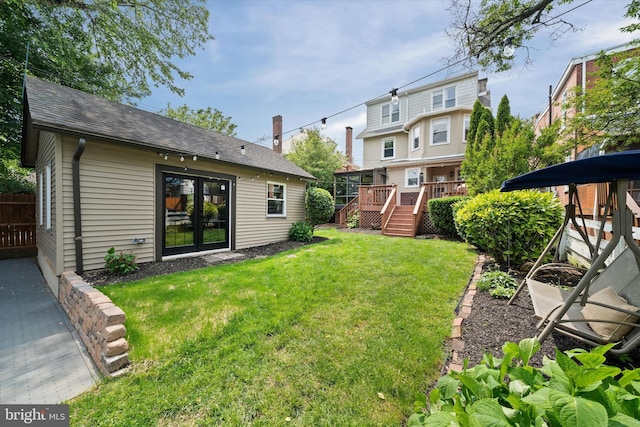 1408 Riverview Ave, Wilmington, DE 19806 - view of grassy yard with a deck, french doors, and stairway