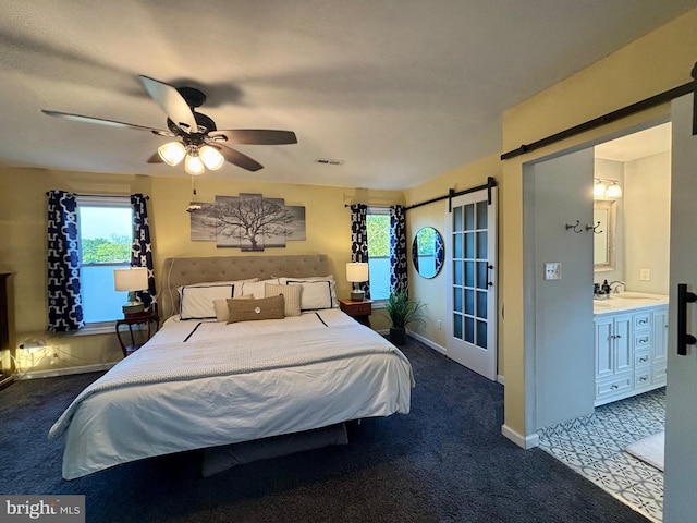 1408 Riverview Ave, Wilmington, DE 19806 - bedroom with a barn door, multiple windows, dark carpet, and a ceiling fan