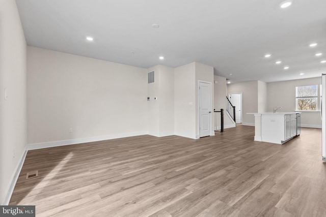 10604 Meridian Hill Way, Upper Marlboro, MD 20772 - unfurnished living room with baseboards, light wood-style floors, recessed lighting, and a sink