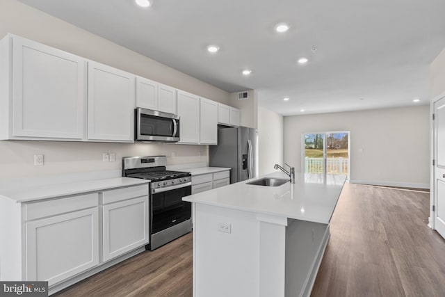 10604 Meridian Hill Way, Upper Marlboro, MD 20772 - kitchen featuring stainless steel appliances, a sink, wood finished floors, a center island with sink, and white cabinets